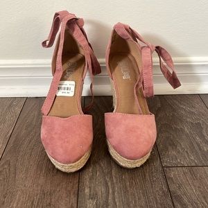 Pink wedges with wrap ties.